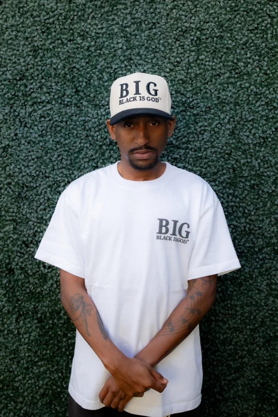 Model wearing BLACK IS GOD® apparel and cap